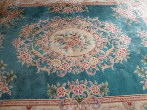 Detail of giant aubusson rug in a french chinese style with peonies